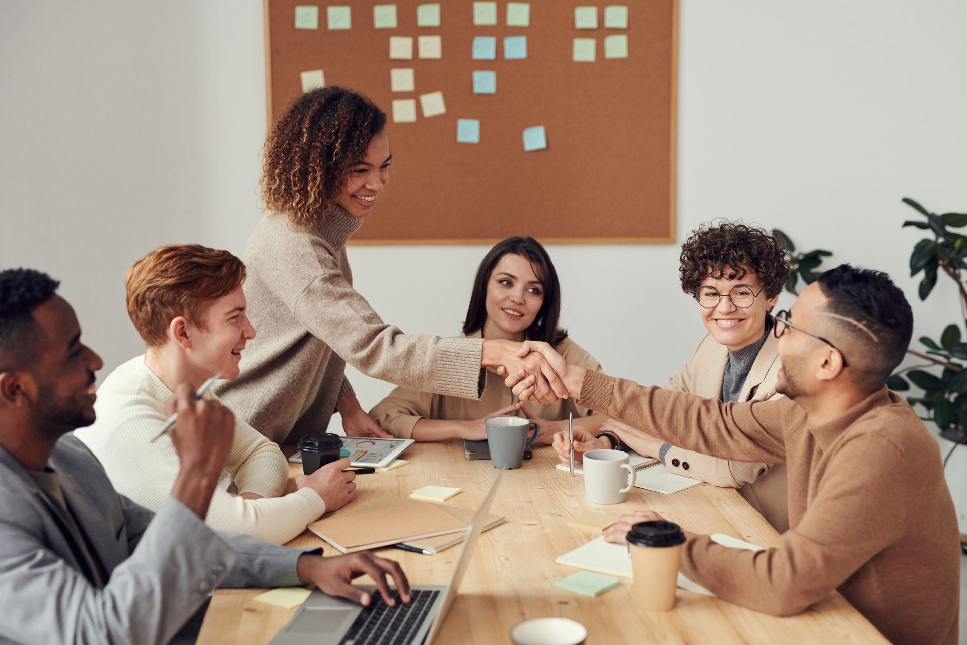 A desk with a laptop and notes at the end of the day